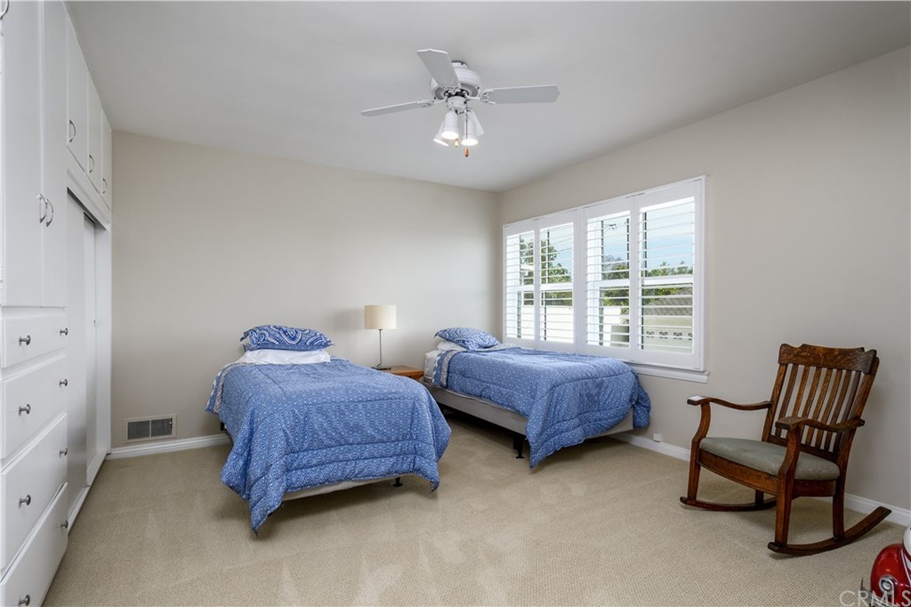 12430 Beverly Drive Whittier, CA 90601 - Photo 19 of 31 a bedroom with two beds and a chair