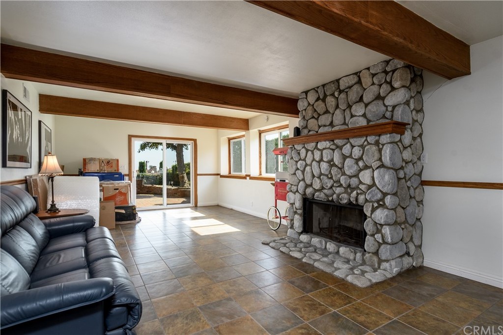 12430 Beverly Drive Whittier, CA 90601 - Photo 22 of 31 a living room with furniture a fireplace and a window