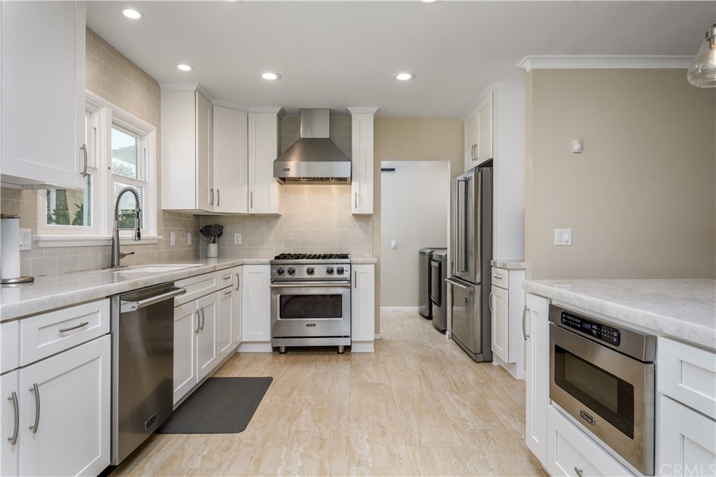 12430 Beverly Drive Whittier, CA 90601 - Photo 8 of 31 a kitchen with stainless steel appliances a stove a sink and a refrigerator