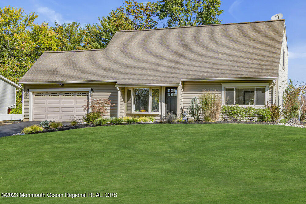 8 Hillside Road Manalapan, NJ 07726 - Photo 1 of 59 a front view of a house with a garden