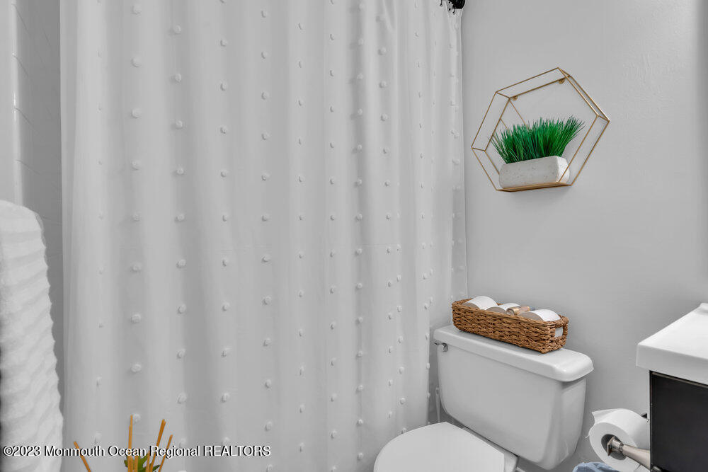 8 Hillside Road Manalapan, NJ 07726 - Photo 35 of 59 a white toilet sitting next to a shower curtain