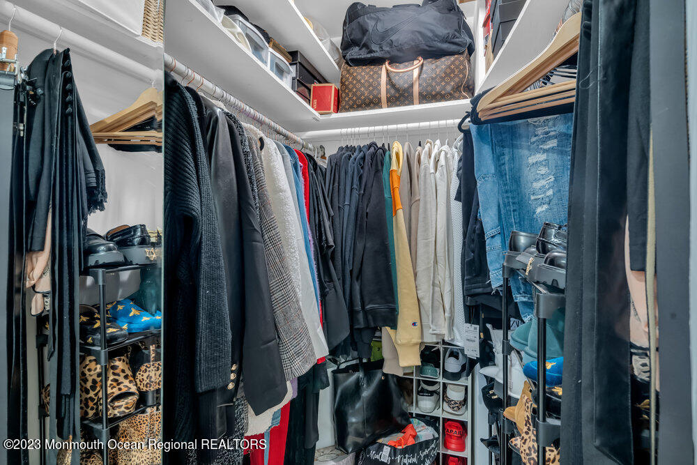 8 Hillside Road Manalapan, NJ 07726 - Photo 42 of 59 a view of walk in closet with clothes and shoes