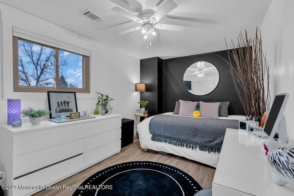 8 Hillside Road Manalapan, NJ 07726 - Photo 44 of 59 a bedroom with a bed and a chandelier