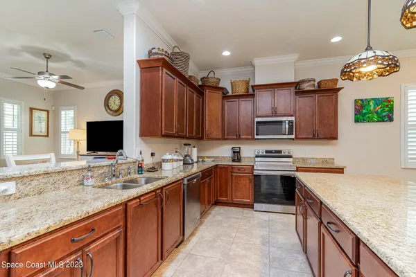 a kitchen with granite countertop a sink stove and cabinets