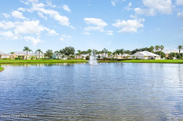 a view of a lake with houses in the back