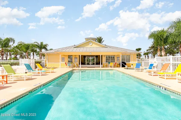 a view of a house with swimming pool and a yard