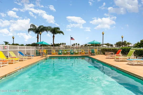 a view of a swimming pool with an outdoor seating