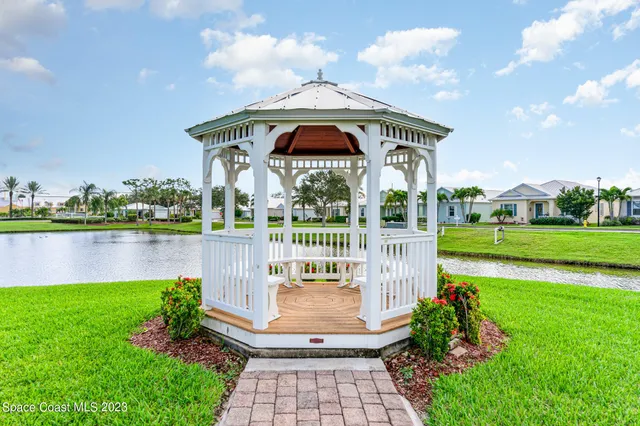 a front view of a house with a yard table and chairs