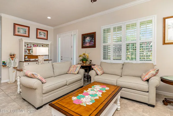 a living room with furniture a rug and a window