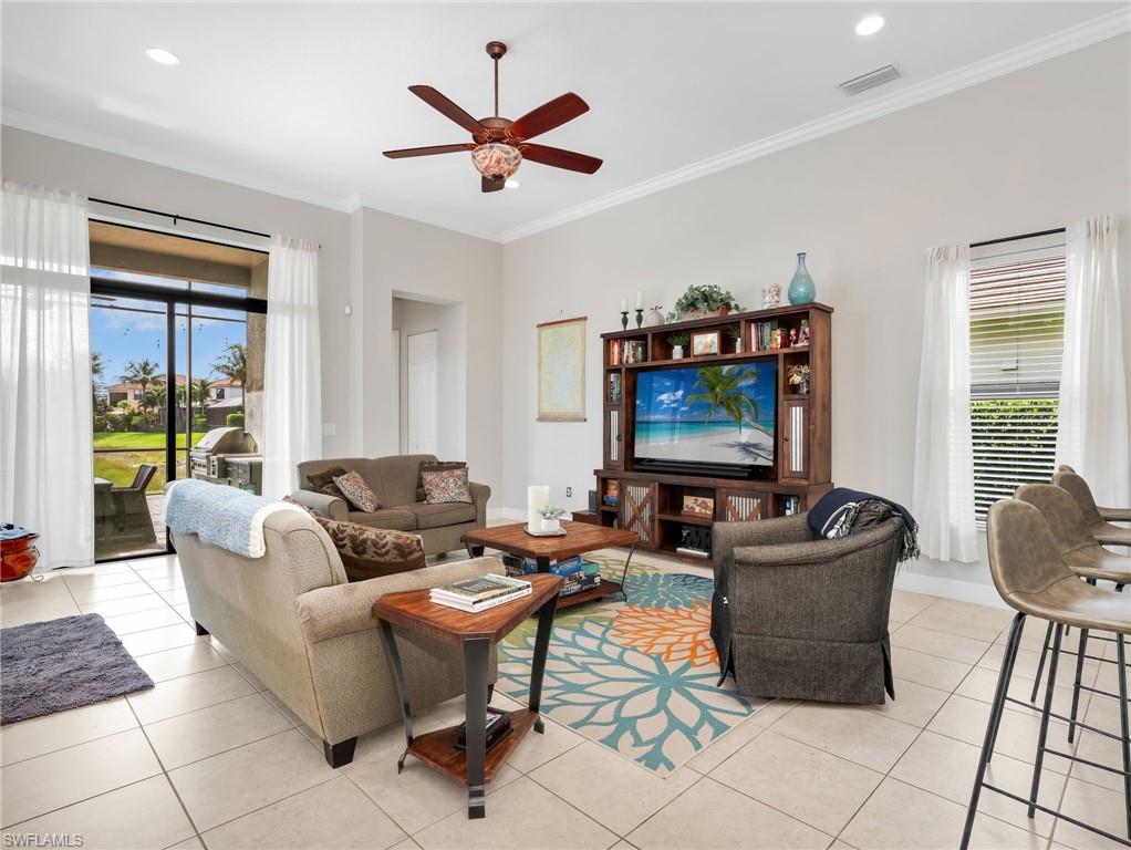 2756 Crystal Way Naples, FL 34119 - Photo 25 of 50 a living room with furniture and a flat screen tv