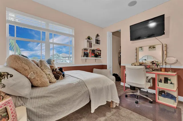 a bedroom with a bed and a flat screen tv