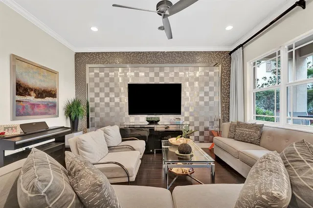 a living room with furniture wooden floor and a flat screen tv