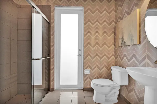 a white toilet sitting next to a shower curtain