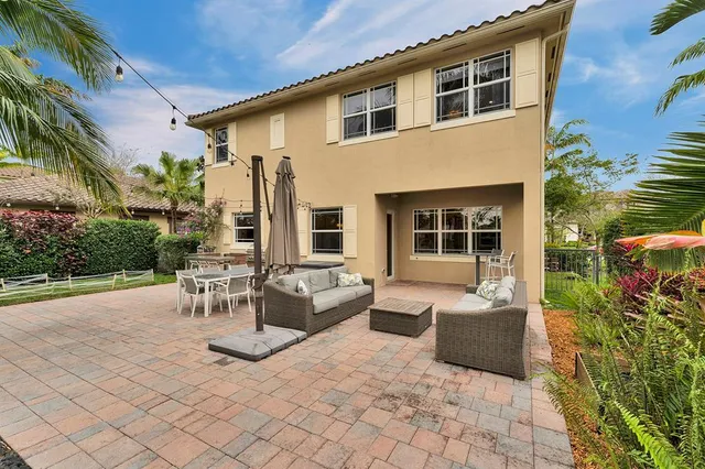 a view of a patio with couches and potted plants