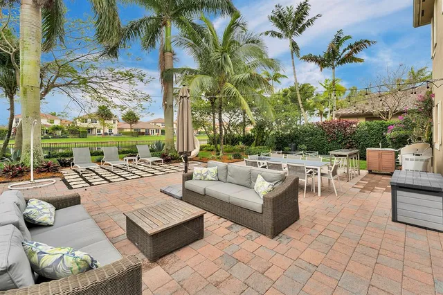 a view of a patio with couches and a fire pit