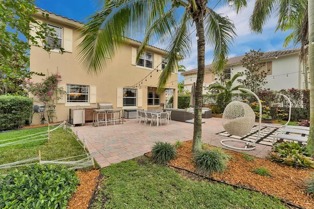 a view of a house with backyard and sitting area