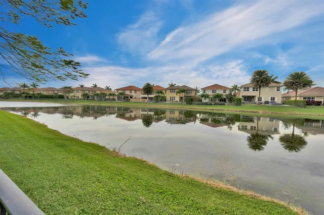 a view of a lake with houses in the back