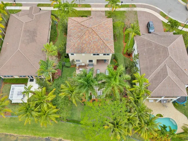 an aerial view of a house with a yard swimming pool and outdoor space