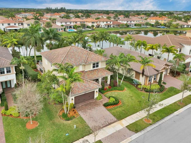 an aerial view of residential houses with outdoor space and river