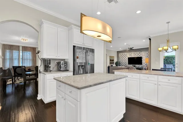 a large kitchen with kitchen island a sink table and chairs