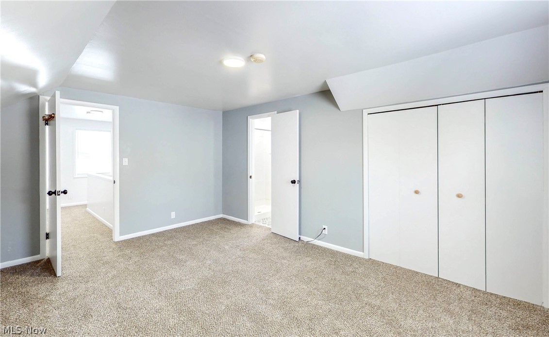 1844 Oakmount Road Cleveland, OH 44121 - Photo 14 of 26 Unfurnished bedroom with carpet flooring, a closet, and vaulted ceiling