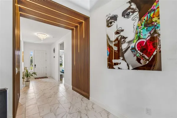 a view of a hallway with entryway and hall with wooden floor