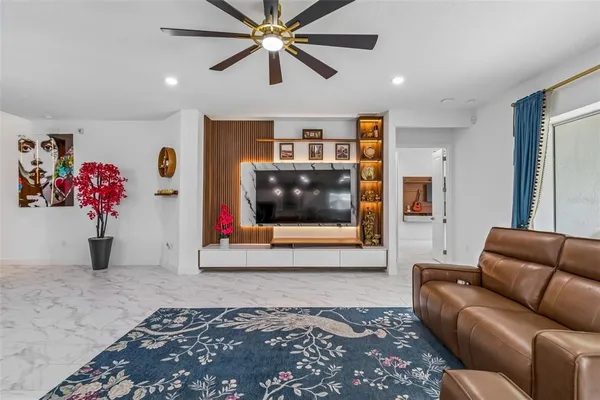 a living room with lots of furniture and view of kitchen