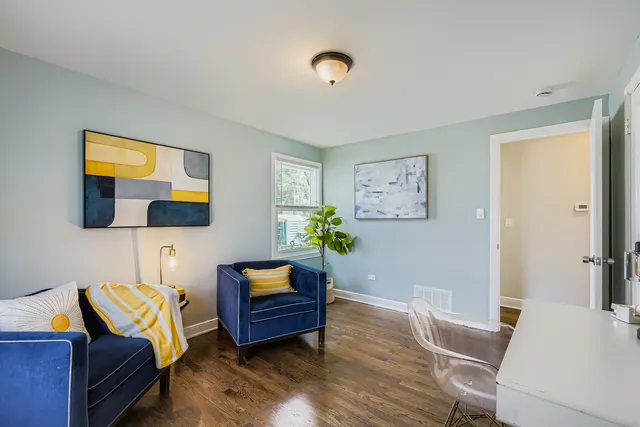 a living room with furniture and a lamp