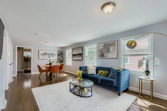 a living room with furniture and wooden floor
