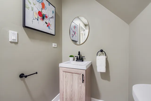 a bathroom with a wall painting on the wall and a window