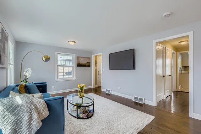 a living room with furniture and wooden floor
