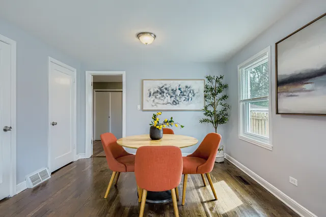a dining room with furniture and window