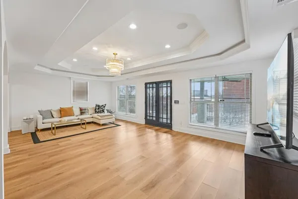 a large kitchen with stainless steel appliances granite countertop a stove a sink dishwasher and cabinets with wooden floor