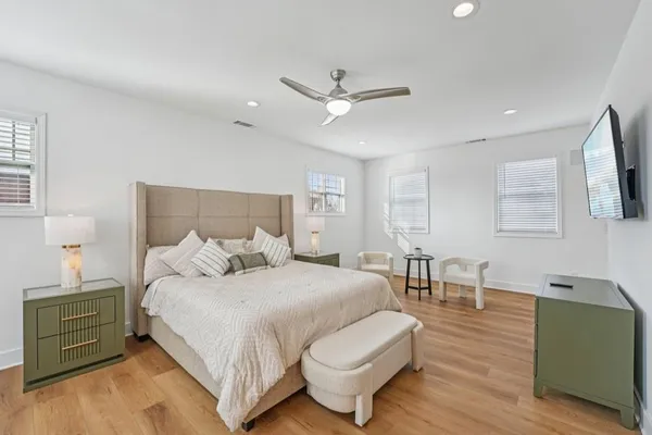 a bedroom with a bed and a night stand
