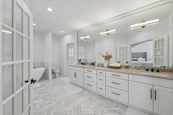 a bathroom with a double vanity sink toilet and shower