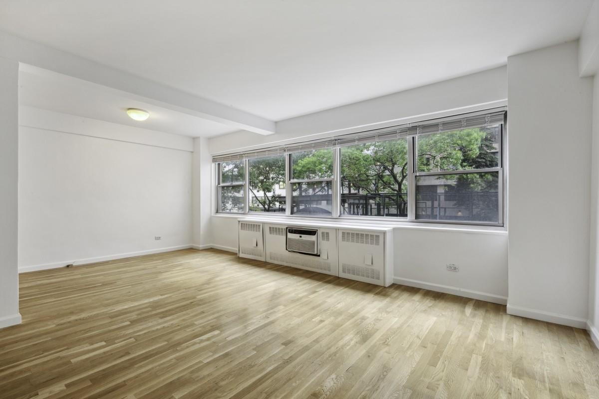 333 East 46th Street, Unit 2C Manhattan, NY 10017 - Photo 1 of 5 wooden floor in an empty room with a window