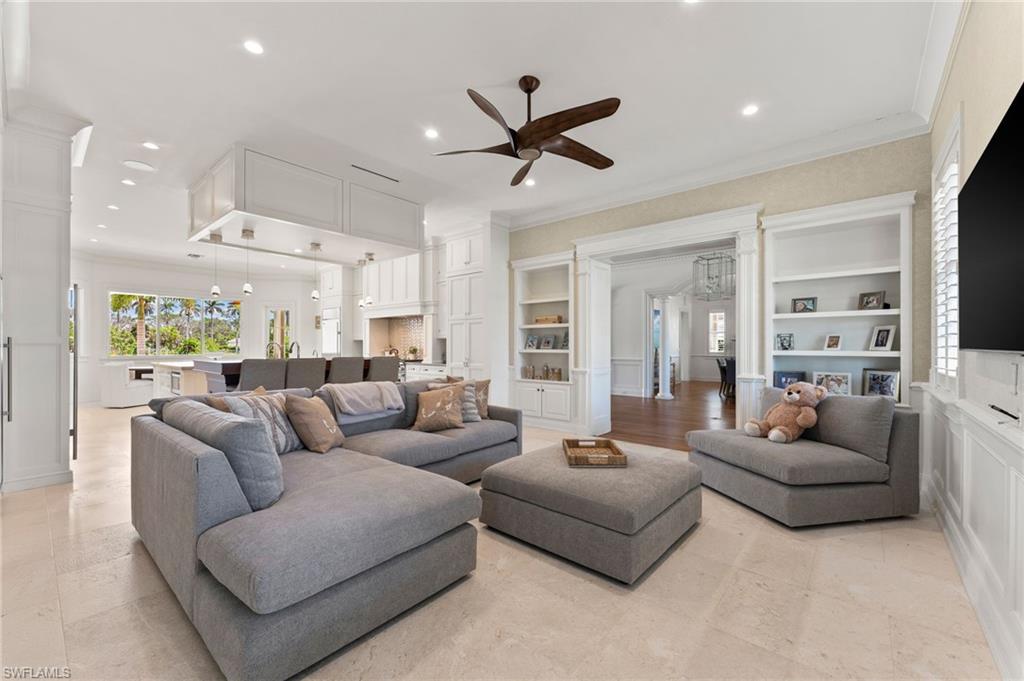 2325 Lantern Lane Naples, FL 34102 - Photo 15 of 50 Living room with recessed lighting, built in features, ornamental molding, and a ceiling fan