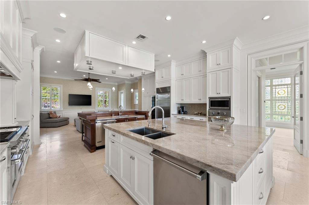 2325 Lantern Lane Naples, FL 34102 - Photo 50 of 50 Kitchen featuring a large island, built in appliances, a sink, open floor plan, and crown molding