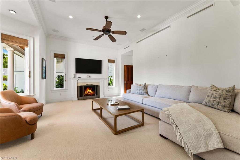 2325 Lantern Lane Naples, FL 34102 - Photo 22 of 50 Living room featuring crown molding, a healthy amount of sunlight, and visible vents