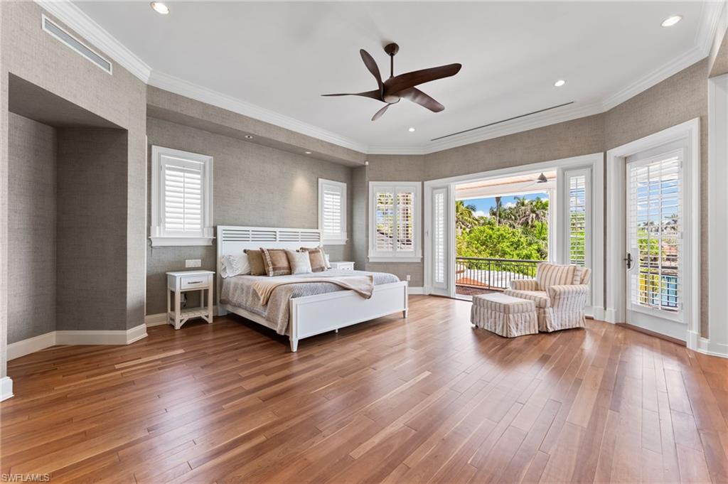 2325 Lantern Lane Naples, FL 34102 - Photo 29 of 50 Bedroom with access to outside, baseboards, and hardwood / wood-style floors