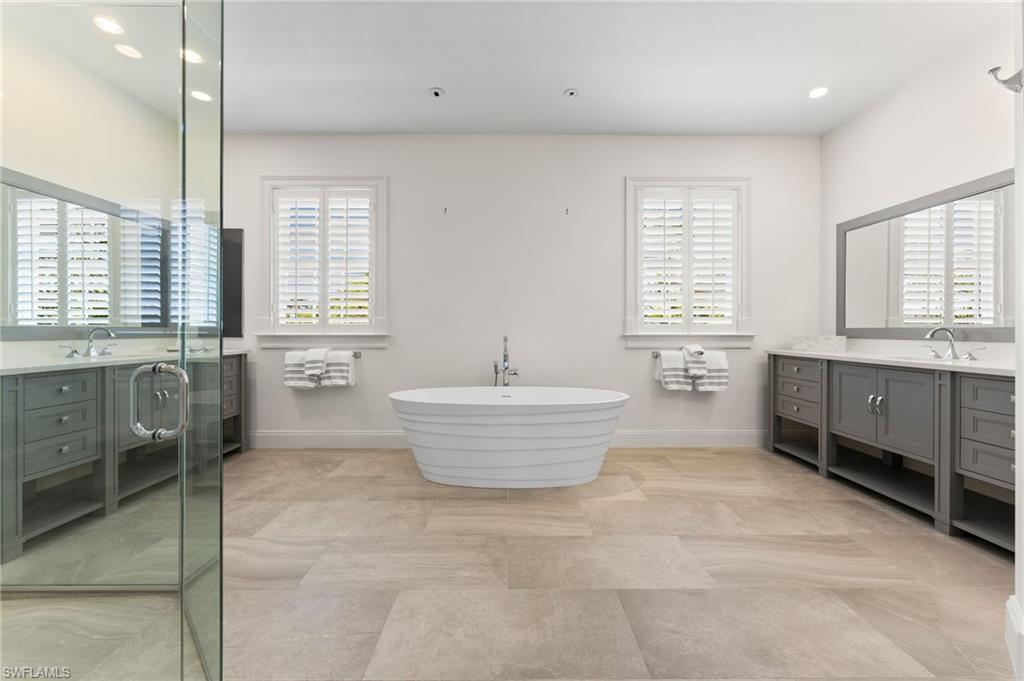 2325 Lantern Lane Naples, FL 34102 - Photo 31 of 50 Bathroom with a soaking tub, a shower stall, vanity, recessed lighting, and baseboards