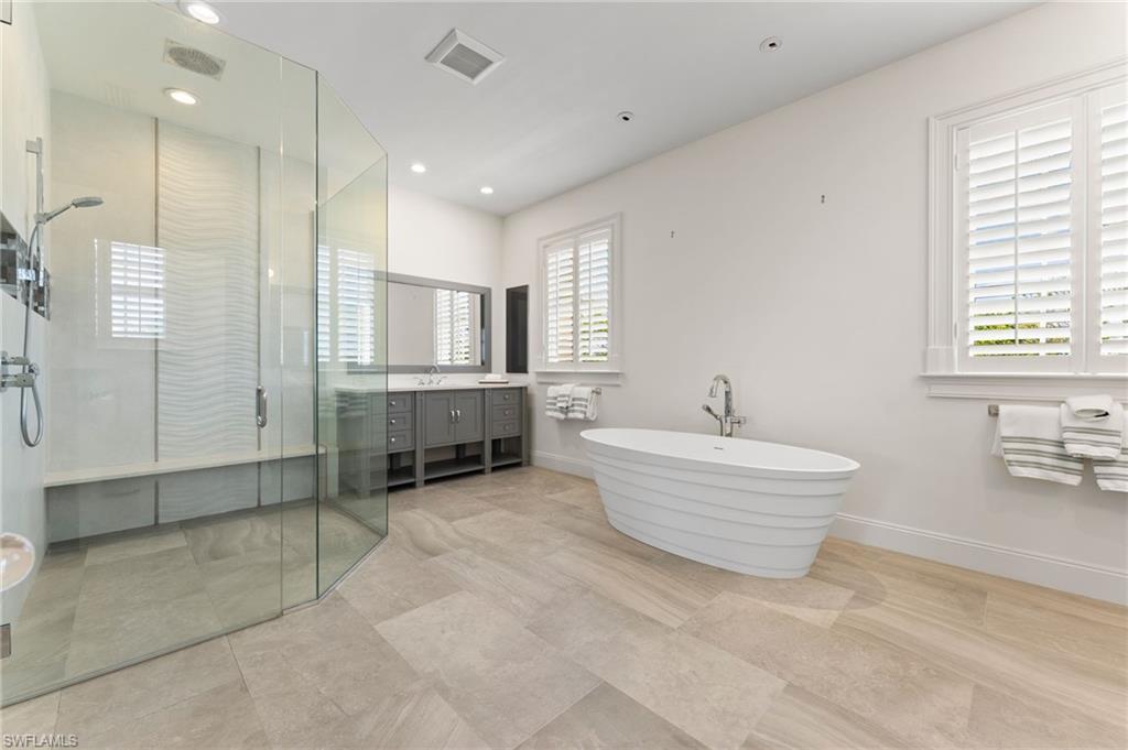 2325 Lantern Lane Naples, FL 34102 - Photo 32 of 50 Full bath with vanity, a stall shower, a soaking tub, recessed lighting, and visible vents