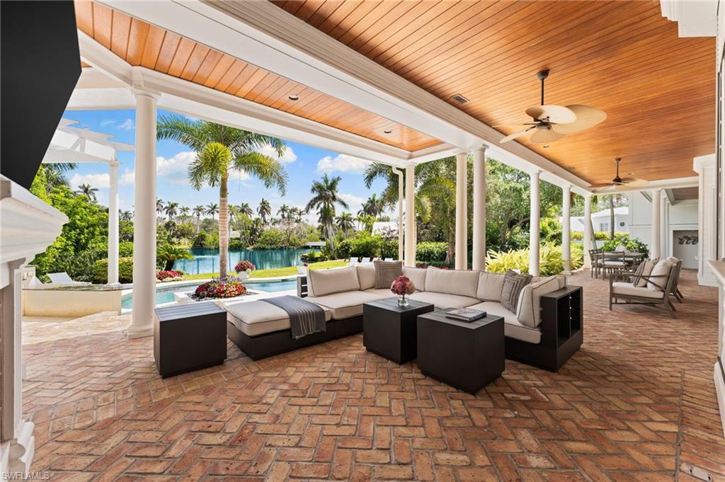 2325 Lantern Lane Naples, FL 34102 - Photo 39 of 50 View of patio with a water view, a ceiling fan, an outdoor hangout area, and an outdoor pool
