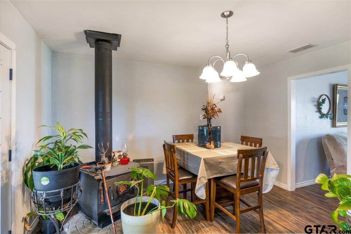 2954 Highway 322 Longview, TX 75603 - Photo 12 of 30 a dining room filled chandelier and wooden floor