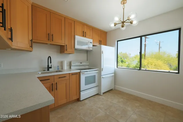 a kitchen with stainless steel appliances granite countertop a stove sink and cabinets