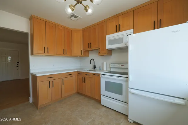 a kitchen with stainless steel appliances granite countertop cabinets and a sink