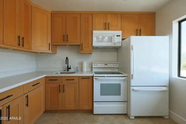 a kitchen with cabinets and stainless steel appliances