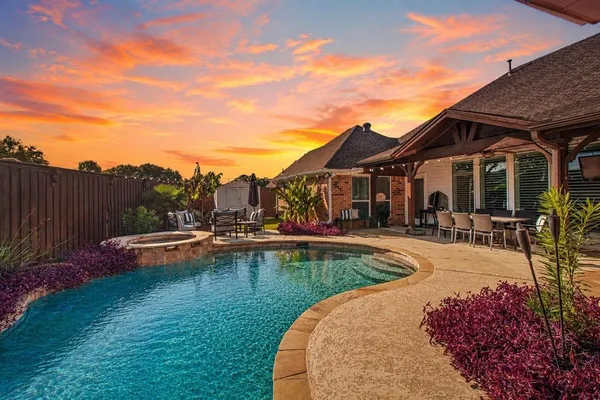 a view of a house with swimming pool and sitting area