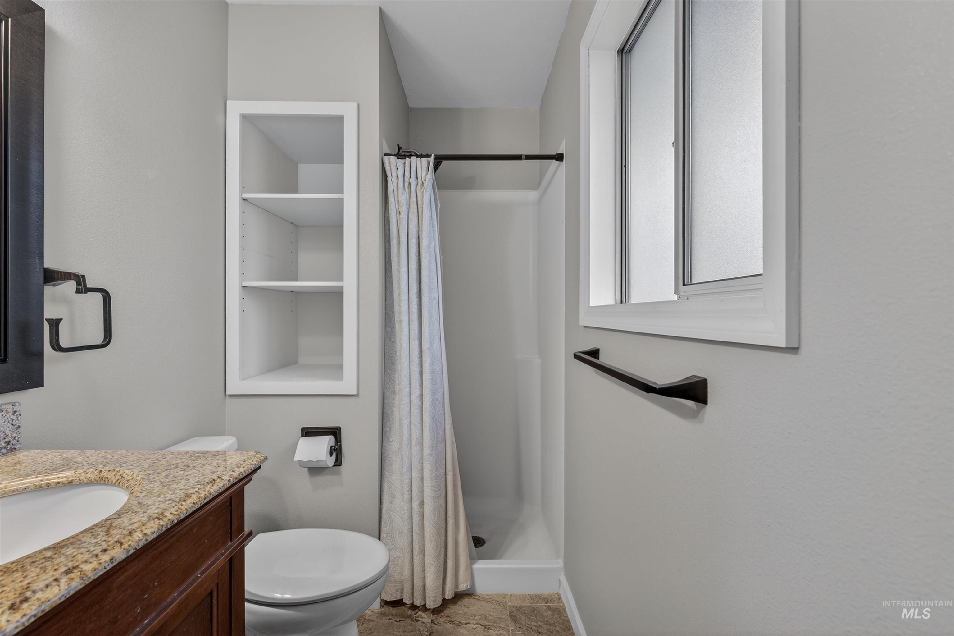 2814 22nd Street Clarkston, WA 99403 - Photo 15 of 33 Full bathroom with a shower stall, vanity, and light stone finish flooring