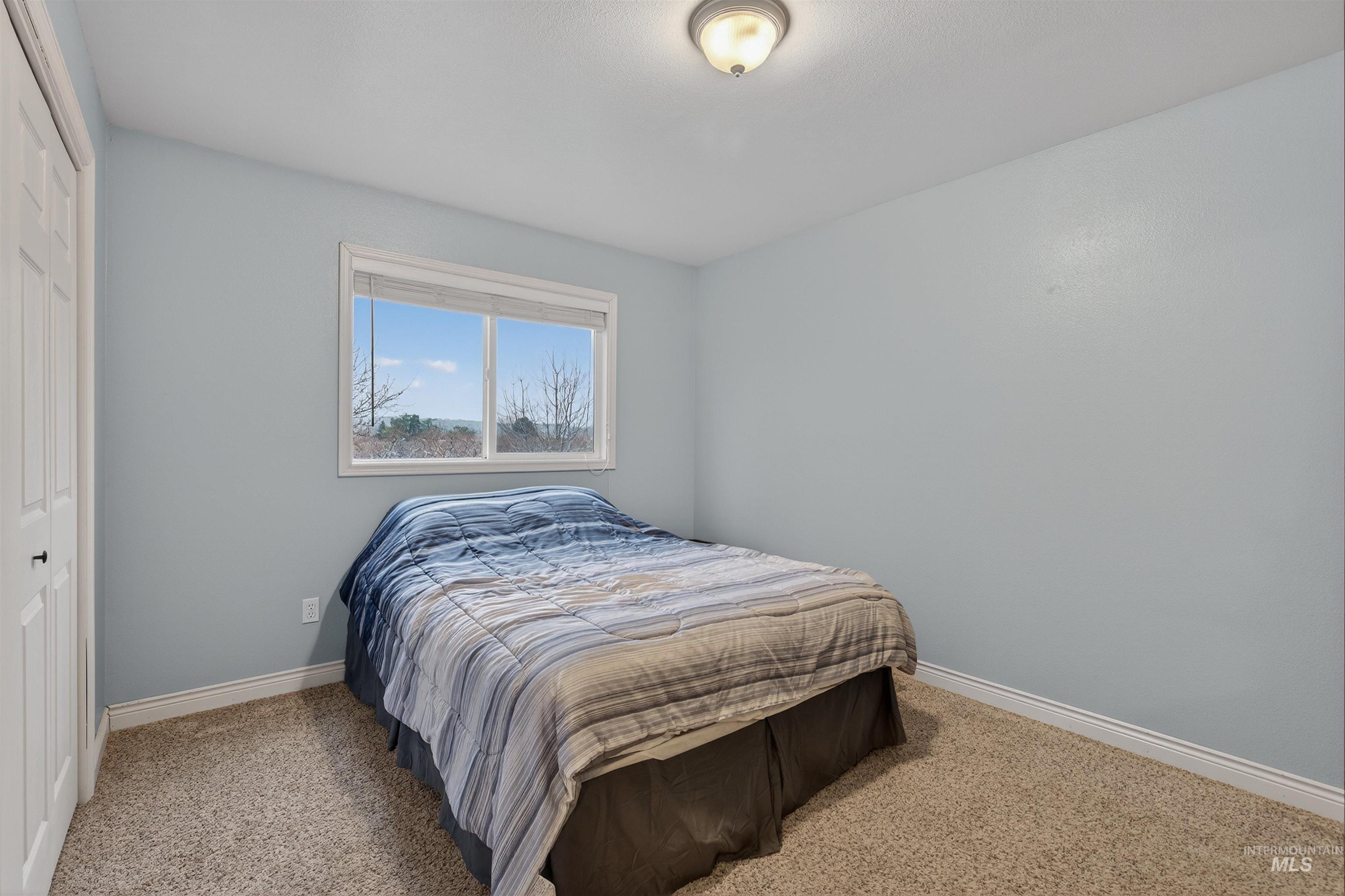 2814 22nd Street Clarkston, WA 99403 - Photo 16 of 33 Bedroom with a closet and light colored carpet